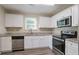 Kitchen with white shaker cabinets, granite countertops, and stainless steel appliances at 280 Green Commons Dr, Covington, GA 30016