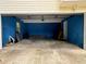 Garage with blue walls and concrete floor at 7267 Wildflower Walk, Winston, GA 30187