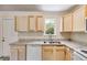 Efficient kitchen featuring granite countertops and wood cabinets at 6085 Hotel St, Austell, GA 30106