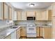 Charming kitchen with light wood cabinets and granite counters at 6085 Hotel St, Austell, GA 30106