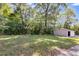 Large backyard with mature trees and detached shed at 6085 Hotel St, Austell, GA 30106