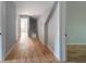 Light-filled hallway with hardwood floors and access to bedrooms at 1630 Ezra Church Nw Dr, Atlanta, GA 30314