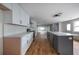 Modern kitchen featuring white cabinets, a gray island, and hardwood floors at 1630 Ezra Church Nw Dr, Atlanta, GA 30314