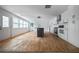 Open concept kitchen with white cabinets, gray island, and hardwood floors at 1630 Ezra Church Nw Dr, Atlanta, GA 30314