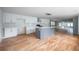Modern kitchen with white cabinets, gray island, and hardwood floors at 1630 Ezra Church Nw Dr, Atlanta, GA 30314