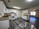 Spacious kitchen featuring granite countertops and white cabinetry at 9151 Spillers Sw Dr, Covington, GA 30014