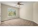 Well-lit bedroom with carpeted floors and a large window at 129 Gold Mill Pl, Canton, GA 30114