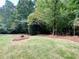 Landscaped backyard with pine straw and lush greenery at 8606 Creekview Ct, Douglasville, GA 30135