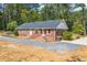 Brick ranch house with gravel driveway and landscaping at 1382 Varner Rd, Marietta, GA 30062