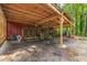 Covered storage area with wood storage and various yard tools at 1382 Varner Rd, Marietta, GA 30062