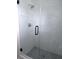 Modern shower with marble-look tile and glass enclosure at 115 Mcferrin Pl, Riverdale, GA 30274