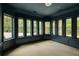 Study with dark walls, built-in shelving, and multiple windows at 8350 Farmette Bnd, Chattahoochee Hills, GA 30268