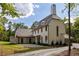 A charming two-story home with a stone chimney, and a spacious backyard at 8350 Farmette Bnd, Chattahoochee Hills, GA 30268