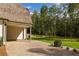 Gravel driveway with landscaping and access to garage at 8350 Farmette Bnd, Chattahoochee Hills, GA 30268