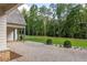 Side yard with gravel landscaping and beautiful trees at 8350 Farmette Bnd, Chattahoochee Hills, GA 30268
