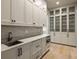 Spacious butler's pantry with white cabinetry and built-in microwave at 8350 Farmette Bnd, Chattahoochee Hills, GA 30268