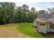 Landscaped yard with lush green grass and beautiful trees at 8350 Farmette Bnd, Chattahoochee Hills, GA 30268