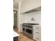 Modern kitchen features a professional-grade range and marble backsplash at 8350 Farmette Bnd, Chattahoochee Hills, GA 30268