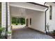 Covered parking with a brick paved driveway leading to the garage at 8350 Farmette Bnd, Chattahoochee Hills, GA 30268
