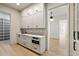 Well-appointed butler's pantry with white shaker cabinets and marble countertops at 8350 Farmette Bnd, Chattahoochee Hills, GA 30268