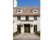 Front view of a charming home with a double front door and stone accents at 8350 Farmette Bnd, Chattahoochee Hills, GA 30268