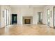 Bright living room with hardwood floors, fireplace, and large windows at 8350 Farmette Bnd, Chattahoochee Hills, GA 30268