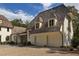 Detached two-car garage with a charming exterior and large doors at 8350 Farmette Bnd, Chattahoochee Hills, GA 30268