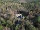 Aerial view of a home nestled in a wooded area, showcasing its private setting at 8350 Farmette Bnd, Chattahoochee Hills, GA 30268