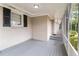 Screened porch with gray flooring and brick walls at 2354 Woodhill Ln, Atlanta, GA 30344