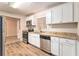 Modern kitchen with white cabinets, granite countertops, and stainless steel appliances at 2354 Woodhill Ln, Atlanta, GA 30344