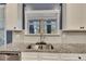 Kitchen detail showcasing granite countertops, double sink, and white cabinets at 3417 Horseback Way, Dacula, GA 30019