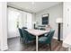 Bright dining room featuring a light wood table and teal velvet chairs at 355 Skylar Se Way, Atlanta, GA 30315