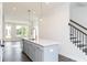 Open kitchen island with a waterfall countertop and stainless steel appliances at 355 Skylar Se Way, Atlanta, GA 30315