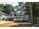 Two-story gray house with black garage door and white porch at 1077 Memory Ln, Lawrenceville, GA 30044