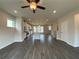 Open concept living room with hardwood floors and kitchen view at 3370 Reagan Way # 84, Lawrenceville, GA 30044