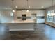 Open concept kitchen with island and white cabinets at 3370 Reagan Way # 84, Lawrenceville, GA 30044