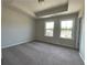 Well-lit bedroom featuring neutral walls and carpet at 3370 Reagan Way # 84, Lawrenceville, GA 30044