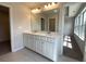 Double vanity bathroom with modern light fixtures and tile flooring at 3370 Reagan Way # 84, Lawrenceville, GA 30044