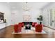 Sitting room with red velvet armchairs, hardwood floors, and a stylish coffee table at 1107 E Beechwood Nw Dr, Atlanta, GA 30327