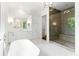 Spa-like bathroom with soaking tub, walk-in shower, and marble flooring at 1107 E Beechwood Nw Dr, Atlanta, GA 30327