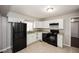 Updated kitchen, white cabinets, granite countertops, black appliances at 2656 County Line Sw Rd, Atlanta, GA 30331