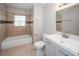 Updated bathroom with new vanity, tile, and bathtub at 2656 County Line Sw Rd, Atlanta, GA 30331