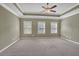 Main bedroom with carpet, ceiling fan, and multiple windows at 2227 W Village Se Ln, Smyrna, GA 30080