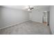 Large bedroom with grey carpet, ceiling fan, and access to laundry at 1468 Briarwood Rd # 805, Brookhaven, GA 30319