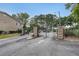 Gated community entrance with stone pillars and automatic gate at 1468 Briarwood Rd # 805, Brookhaven, GA 30319
