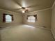 Large bedroom with neutral carpeting and ceiling fan at 1935 Lamp Post Ln, Lawrenceville, GA 30043