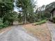 Long driveway leading to the house and surrounded by trees at 1935 Lamp Post Ln, Lawrenceville, GA 30043