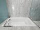 Soaking tub with marble tile and a modern faucet at 45 Ivan Allen Jr Nw Blvd # 2306, Atlanta, GA 30308