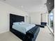 Spacious bedroom with a large tufted bed and city views at 45 Ivan Allen Jr Nw Blvd # 2306, Atlanta, GA 30308