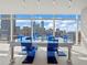 Unique dining area with a glass table and blue chairs at 45 Ivan Allen Jr Nw Blvd # 2306, Atlanta, GA 30308